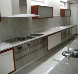 Poyurethane And Venner Kitchen With Stainless Benchtops And Stone Splashbacks