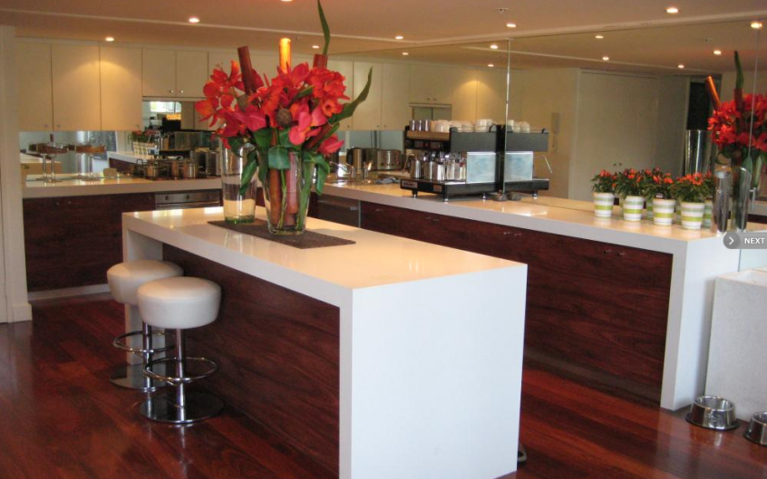 Timber Jarrah kitchen with 80mm benchtops & mirror splashbacks | Tasker